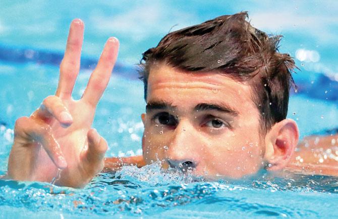 Michael Phelps displays a victory sign after competing in a semi-final heat for the 200m individual medley on Thursday. Pic/AFP