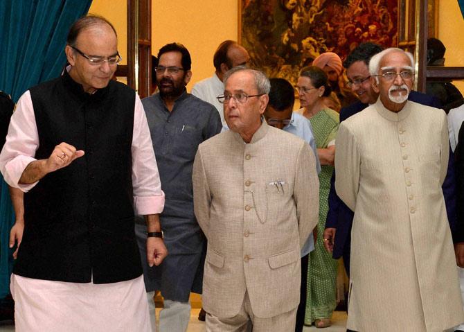 President Pranab Mukherjee with Vice President Hamid Ansari and Finance Minister Arun Jaitley at an Iftar party hosted at the Rashtrapati Bhavan in New Delhi on Friday