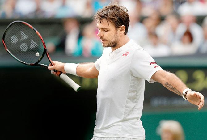 Switzerland’s Stan Wawrinka reacts after losing a point to Argentina’s Juan Martin del Potro during their Wimbledon match in London yesterday. Pic/AFP