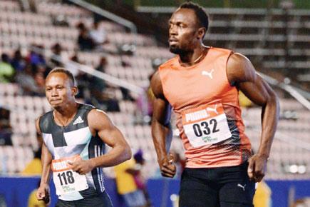 Usain Bolt eases into 100m semi-finals in 10.15 seconds