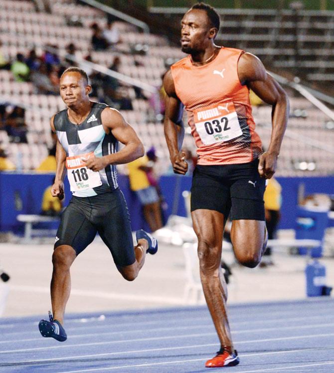 Jamaica’s Usain Bolt (right) during his 100 metres quarter-final heat  in Kingston on Thursday.