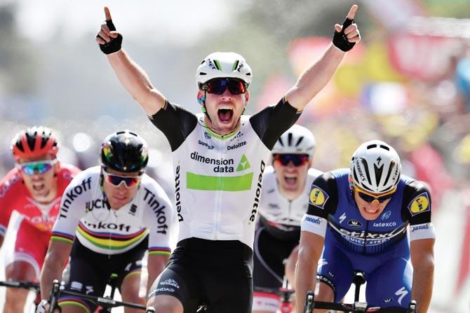 Mark Cavendish celebrates his 1st stage win of the 103rd Tour de France in Normandy, France on Saturday. Pic/AFP