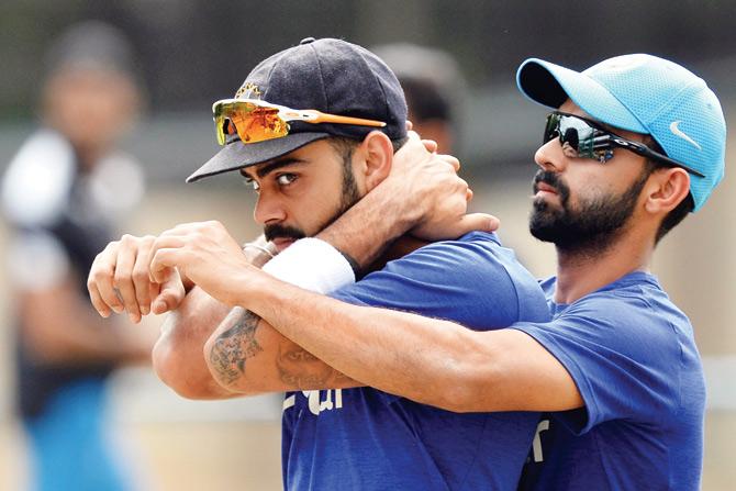India Test captain Virat Kohli (left) does some stretching exercises with Ajinkya Rahane during a practice session at the National Cricket Academy in Bangalore on Saturday. Pic/AFP