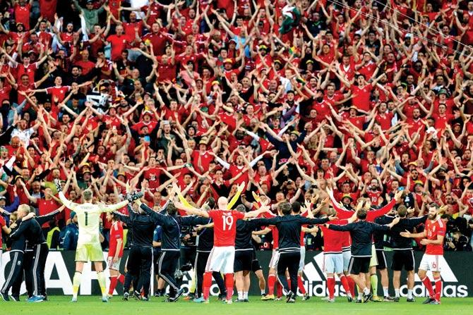 Wales’ players celebrate with fans after their 3-1 win in the Euro 2016 quarter-final football match against Belgium at the Pierre Mauroy stadium in Villeneuve near Lille, France on Friday, PIC:AP/PTI