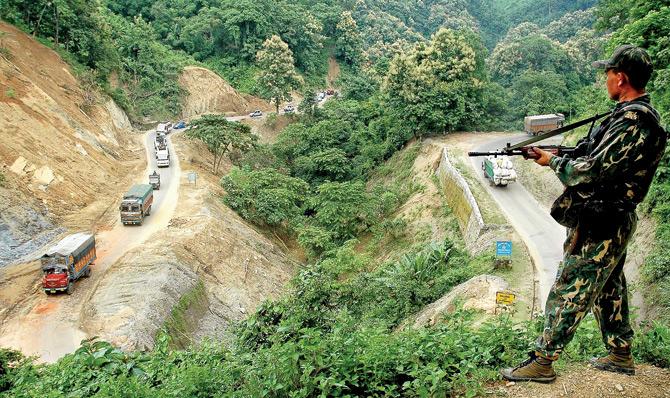 A security force official guarding the National Highway in Tripura 