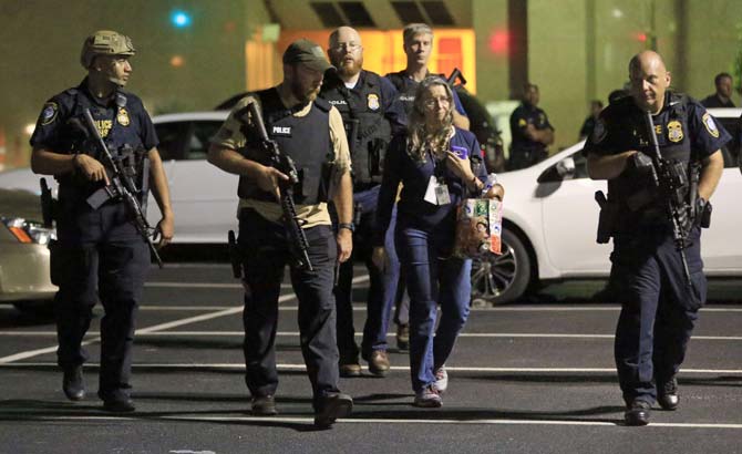 Police stand near a baracade following the sniper shooting in Dallas. Pic/ AFP