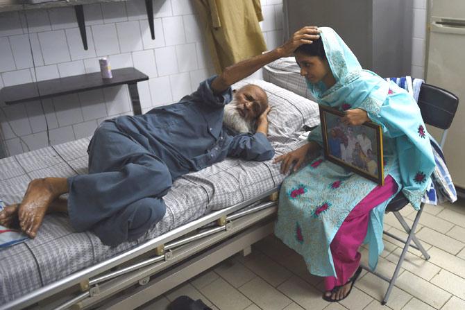 This file photo taken on October 15, 2015 shows Indian woman, Geeta being blessed byAbdul Sattar Edhi, the chairman of Edhi Foundation in Karachi. Abdul Sattar Edhi, died on July 8, 2016, at the age of 92, his son confirmed as tributes swiftly poured in for the humble man almost unanimously revered as a national hero