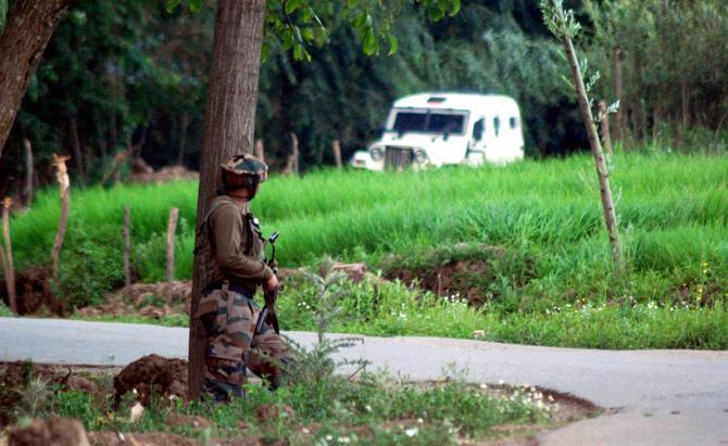 An Army Jawan takes position towards the site where most wanted Hizbul Mujahideen militant commander Burhan Wani along with his two associates were killed during an encounter at Kokarnag area of Anantnag District of South Kashmir on Friday. Pic/ PTI