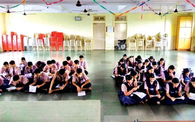 Students learning about the Voice Donation Camp at Powai English High School
