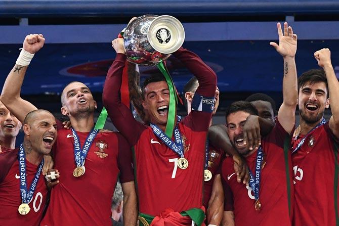 Christiano Ronaldo along with Portugal teammates lifts the Euro 2016 Trophy