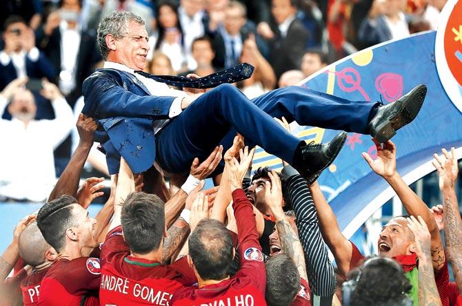 Portugal manager Fernando Santos is hoisted in the air by his players. Pic/AFP