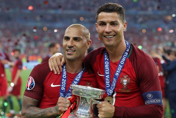Ricardo Quaresma and Cristiano Ronaldo pose with the trophy. Pic/ AFP