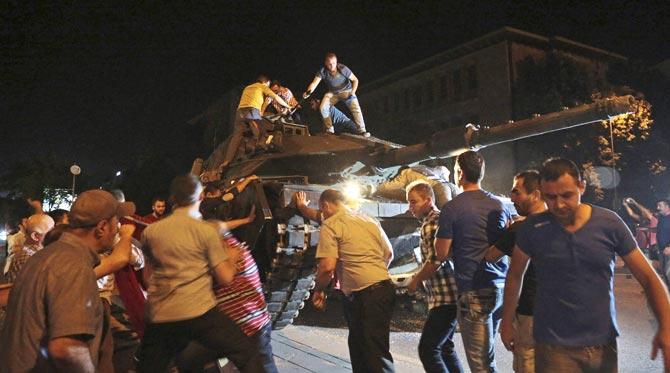 Ankara : A tank moves into position as Turkish people attempt to stop them, in Ankara, Turkey, late Friday, July 15, 2016. Members of Turkey-s armed forces said they had taken control of the country, but Turkish officials said the coup attempt had been repelled early Saturday morning in a night of violence, according to state-run media. Pic/PTI