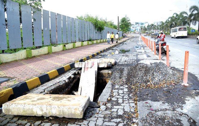 Death trap: A massive pit in the dedicated bus lane in BKC. It has been closed to traffic. Pic/Suresh Karkera