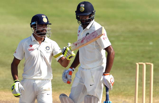 Indian cricketer Ravindra Jadeja (L) celebrates scoring his half-century (50 runs) during Day 2 of the three-day tour match between India and WICB President