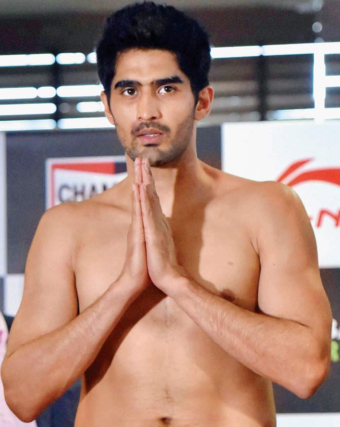 Vijender Singh joins his hand in Sultan-style during the weigh-in ceremony in New Delhi yesterday. Pic/PTI
