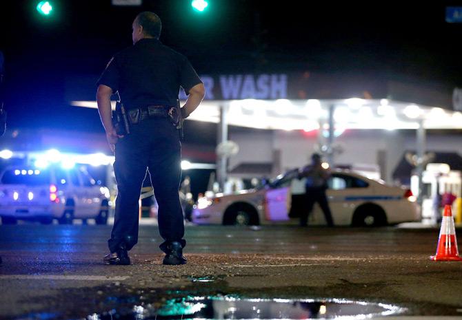 Baton Rouge, LA - JULY 17: Police officers stand near the scene of where three police officers were killed this morning on July 17, 2016 in Baton Rouge, Louisiana. Pic/ AFP