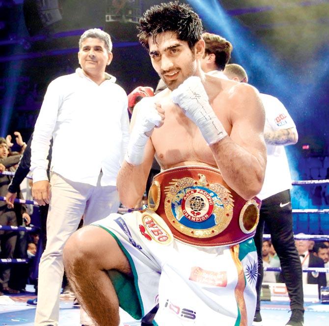 Indian boxer Vijender Singh poses with the WBO Asia Pacific Super Middleweight belt after his win over Australia