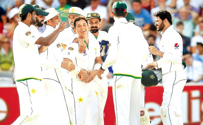 Pakistan spinner Yasir Shah (centre) celebrates the wicket of England