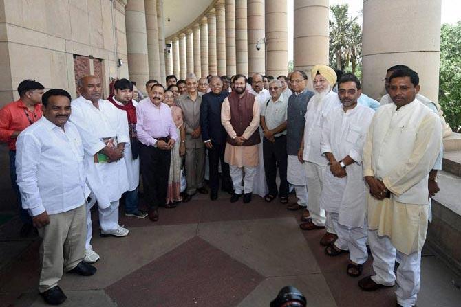 Union HRD Minister Prakash Javadekar poses for a group photo with the MPs from Academic background after they were felicitated on the occasion of Guru Purnima. Pic/ PTI