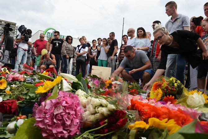 People lay down flowers on July 23, 2016 for the victims of the shooting near the Olympia-Einkaufszentrum shopping centre in Munich, southern Germany. Pic/AFP