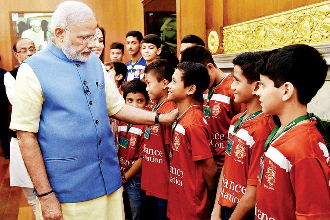 PM Narendra Modi interacts with children at the launch of the Reliance Foundation Youth Sports in New Delhi on Saturday. 