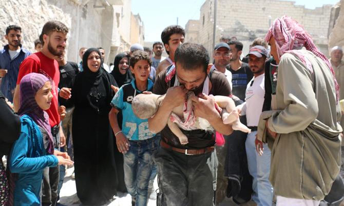 A Syrian man holds the body of his child after it was taken from under the rubble of destroyed buildings following a reported air strike on the rebel-held neighbourhood of al-Marjah in the northern city of Aleppo. Pic/ AFP