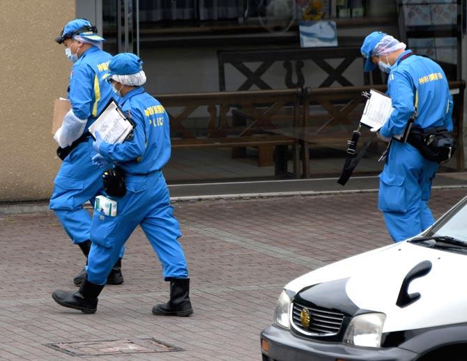 Police officers walk outside the entrance to the Tsukui Yamayuri En care centre where a knife-wielding man went on a rampage in the city of Sagamihara, Kanagawa prefecture. Pic/AFP