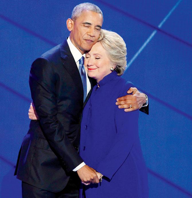 US President Barack Obama and Democratic presidential nominee Hillary Clinton embrace on stage.