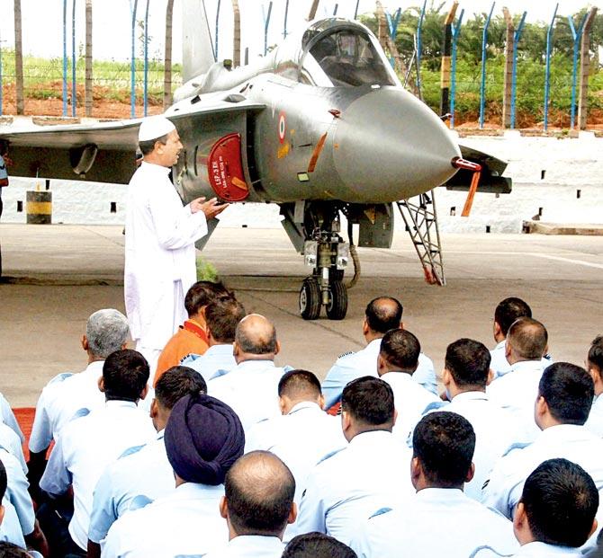 A priest offers prayers during the induction of Tejas into the IAF fold at HAL (ASTE) in Bengaluru yesterday. Pic/PTI
