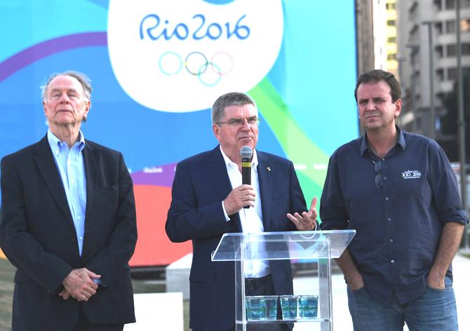 The President of the International Olympic Committee IOC Thomas Bach C, accompanied by Rio de Janeiro-s Mayor Eduardo Paes R and the President of the Local Organising Committee, speaks during a visit at the place where the Olympic flame will light in the Boulevard de la Orla, in front of Guanabara Bay in Rio de Janeiro