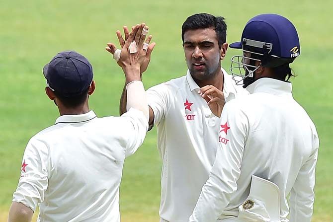 Ravichandran Ashwin celebrates with teammates after bolwing out Shane Dowrich. Pic/ AFP