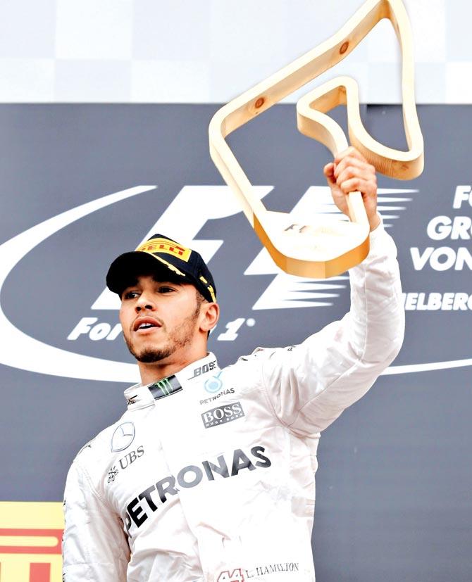 Mercedes driver Lewis Hamilton celebrates his Austrian GP win in Spielberg, Austria yesterday. Pic/Getty Images
