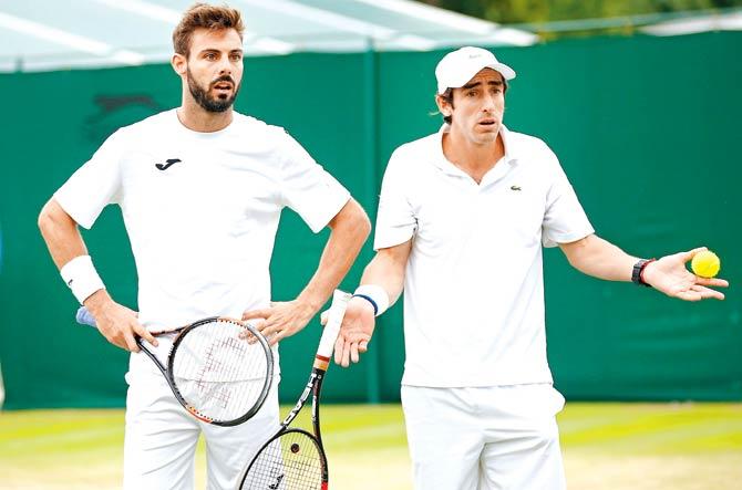 Pablo Cuevas (right) and Marcel Granollers argue with the chair umpire on Monday. Pic/Getty Images