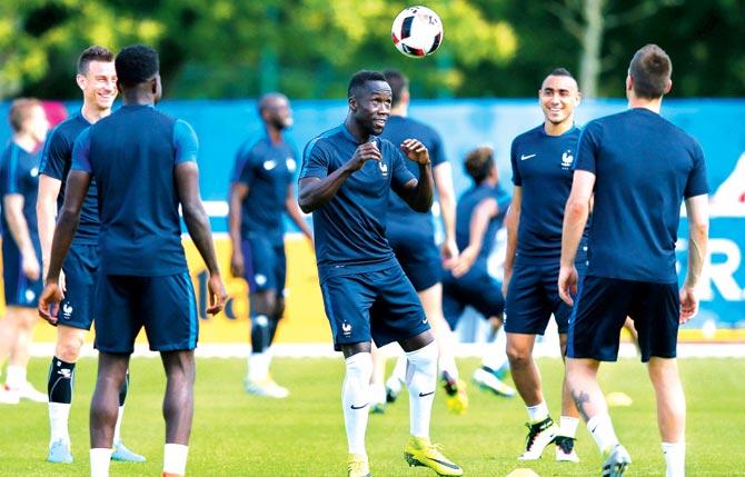 France midfielder Bacary Sagna (centre) heads the ball towards a teammate during a training session in Paris on Saturday. Pic/AFP