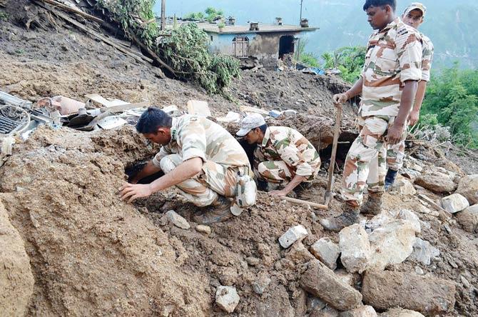This handout photograph released by the Army on Saturday shows Indian soldiers searching for survivors of a landslide following torrential rain in the Pithoragarh area of rural Uttarakhand state. At least dozens  more are missing. Pic/AFP