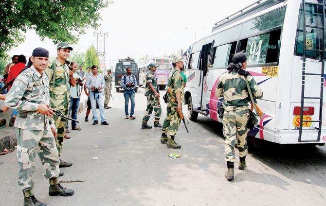 BSF and J&K police search vehicles after a constable stabbed a jawan and fled with weapons, at Beli Azmat post in Jammu yesterday. Pic/PTI
