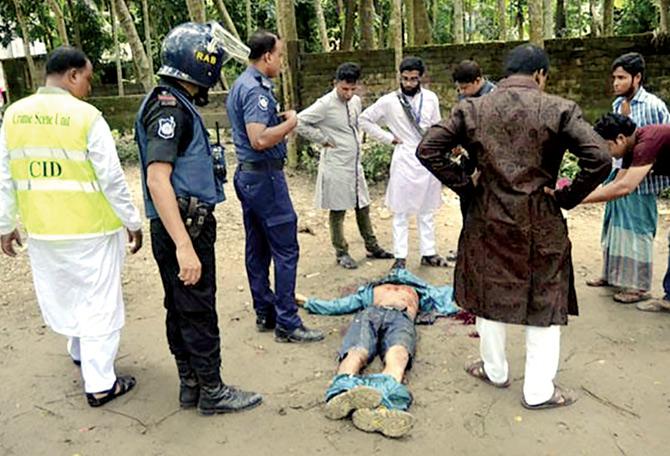Bangladesh police surround the body of a suspected militant following the attack in Kishoreganj yesterday. Pic/AFP