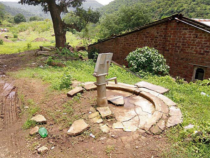 The hand pump that survived the landslide has become a relic today; Makeshift tin sheds have replaced the houses that were destroyed that day; Work under way for a monument for all 151 people who died in the landslide