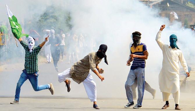 Protests in Kashmir with a youth (extreme left) holding a flag of Pakistan. File Pic
