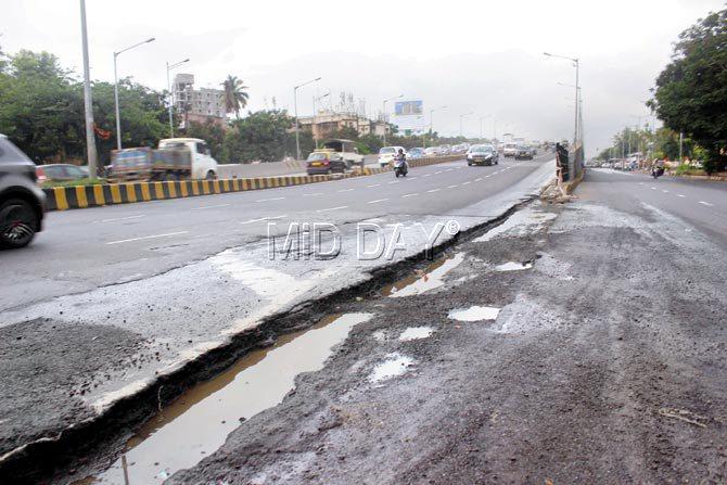 As the skies open, the north arm of the Kherwadi flyover turns into a culverted drain. Rows of potholes and poor drainage have rendered this stretch of the flyover a dangerous zone. Pic/Prabhanjan Dhanu