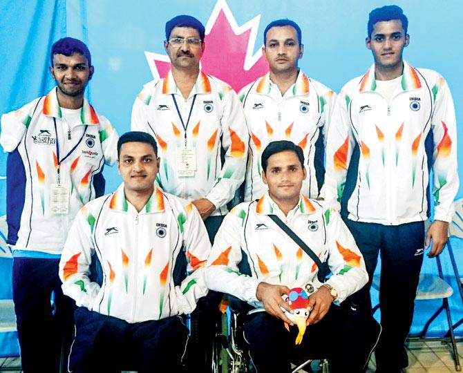 Mohammad Sheikh (sitting left) with his coaches and team members