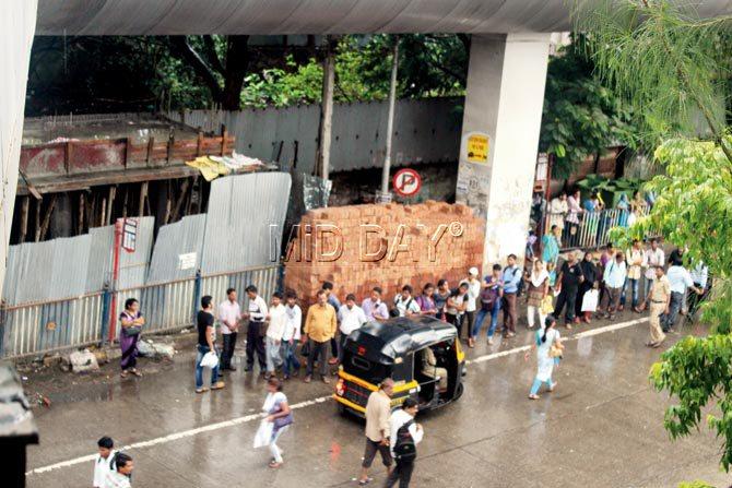 Pedestrians spill over to the road as the footpath is blocked by an under-construction public toilet outside the Andheri railway station. Pics/Prabhanjan Dhanu
