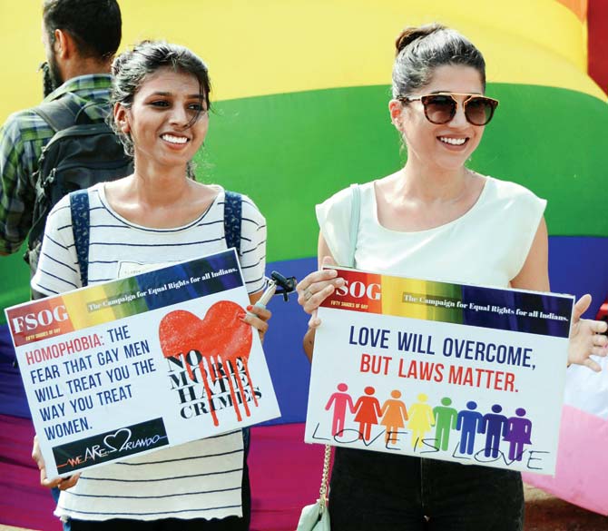 Participants hold placards during a rally held on June 16 at Azad Maidan to express solidarity with the victims of Orlando club massacre. File Pic