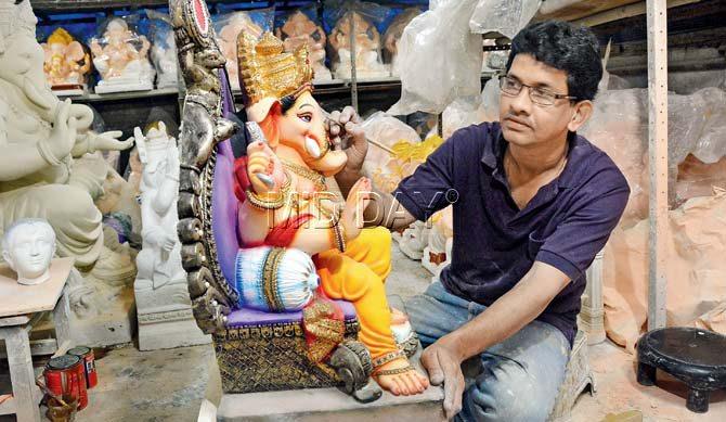 Satish Parab paints Ganpatis at his Sion workshop after wrapping up his day job. Pic/Sayed Sameer Abedi