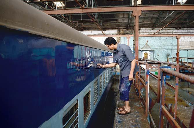 Satish Parab paints coaches at Lower Parel’s Railway workshop from 7 am to 4 pm. Pic/Sneha Kharabe