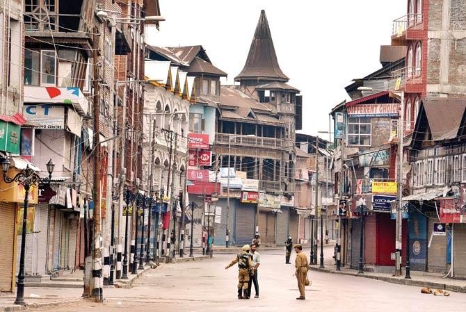 Indian paramilitary troopers stand guard during a curfew in Srinagar on Saturday. Pic/AFP