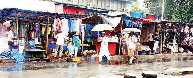 Stalls and hawkers encroach upon the footpath outside Jogeshwari station (east side), forcing pedestrians to walk on the road. Pics/Nimesh Dave