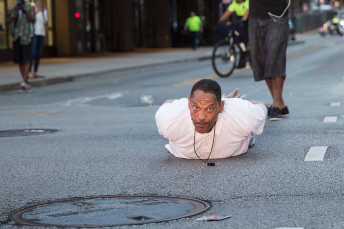 A man lays on the ground after yelling "Don