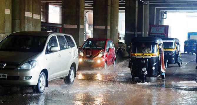 Vehicles plough through the waterlogged stretch under the Western Express Highway Metro station